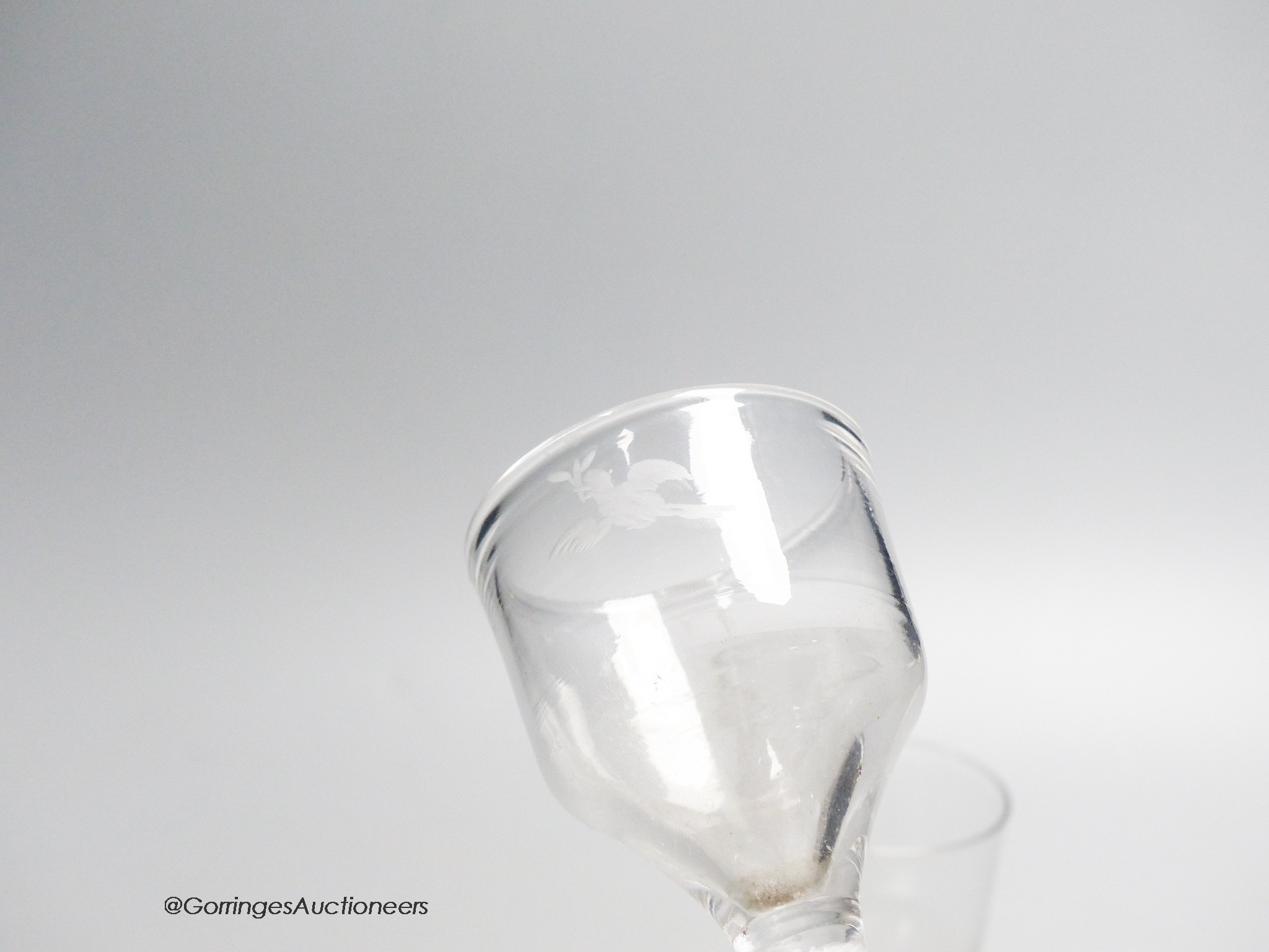 Two Georgian opaque twist stem cordial glasses, each with a funnel bowl, one engraved C B with dove and olive branch, tallest 15cm